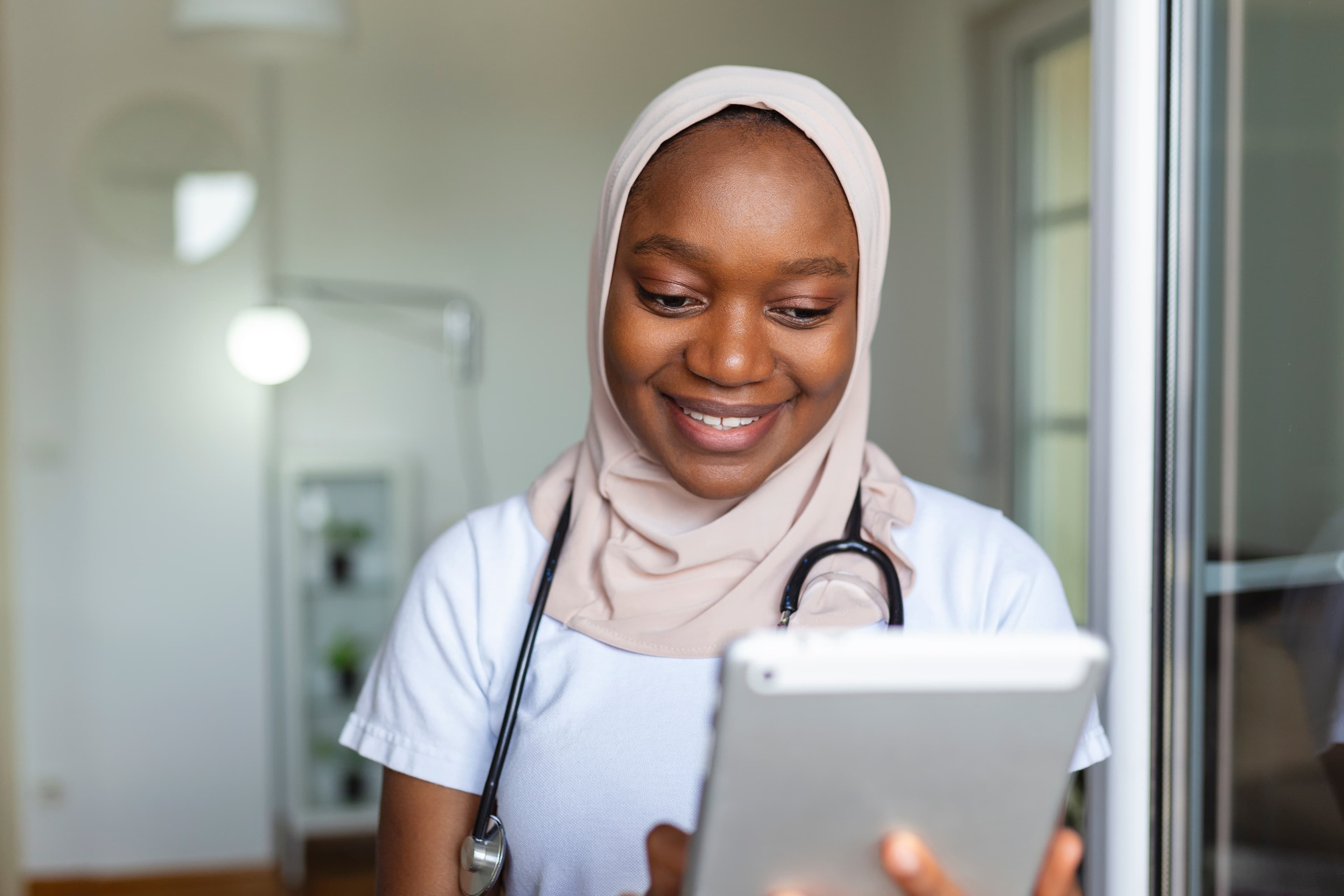 Clinician walking through a busy clinic corridor