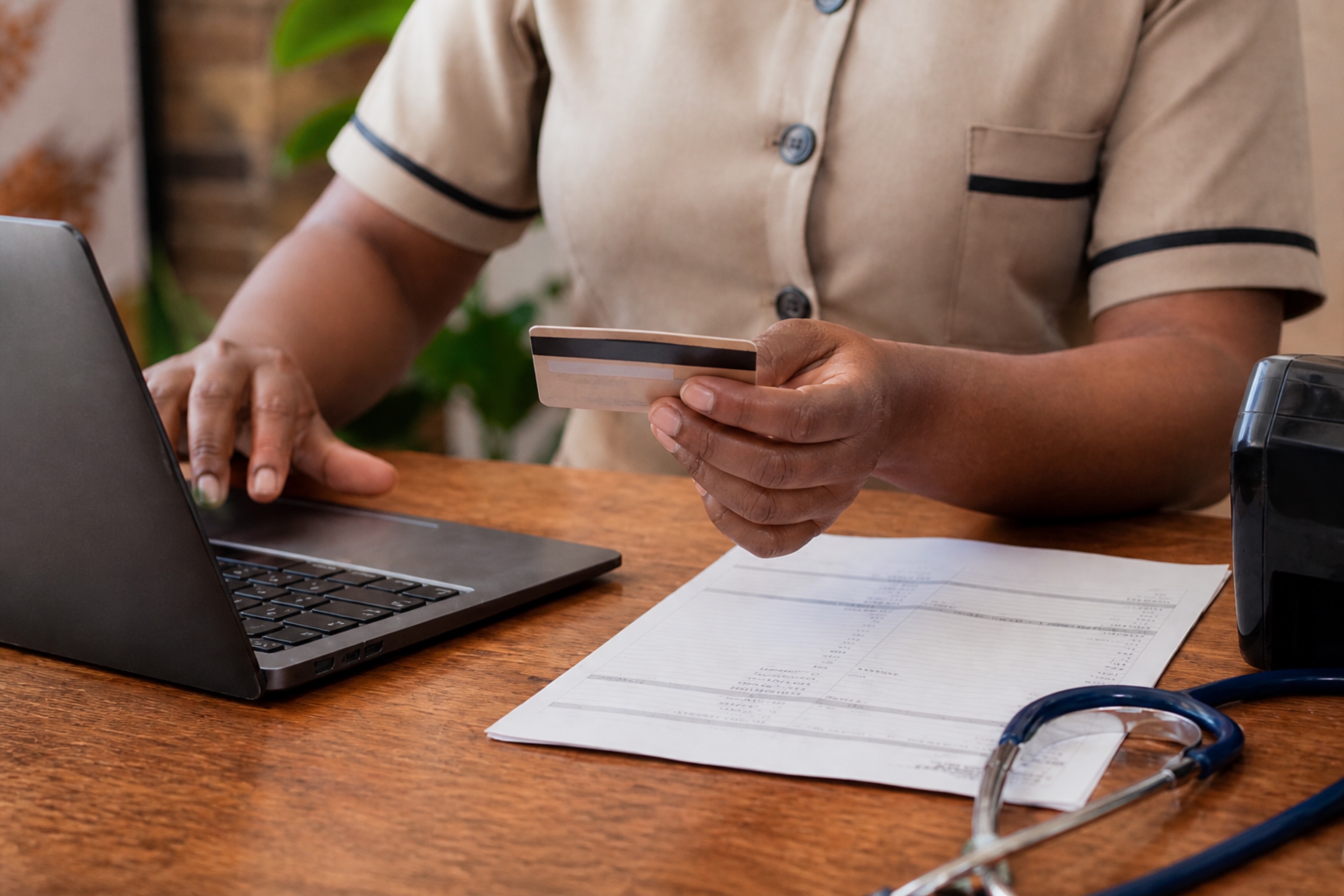 A clinic front desk taking a patient payment